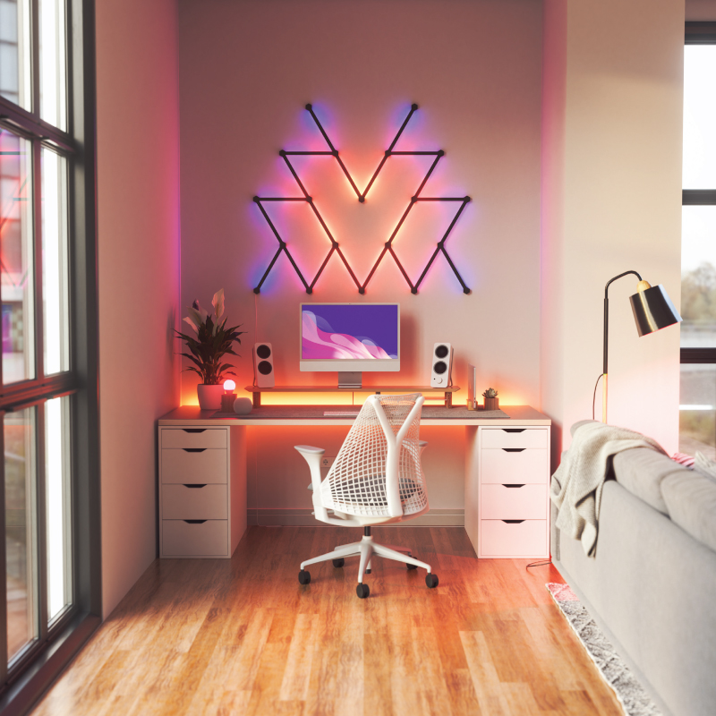 Nanoleaf Lines Thread-enabled color-changing smart modular backlit light lines skin mounted to a wall in a home office. Matte black. HomeKit, Google Assistant, Amazon Alexa, IFTTT.