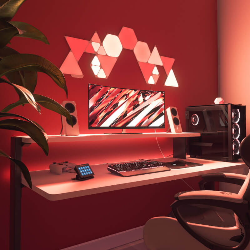 Nanoleaf Shapes Thread enabled color changing hexagon smart modular light panels mounted to a wall above a battlestation. Similar to Philips Hue, Lifx. HomeKit, Google Assistant, Amazon Alexa, IFTTT.